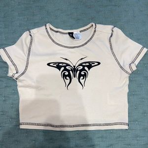 A size xtra small to shirt with butterfly design on front
